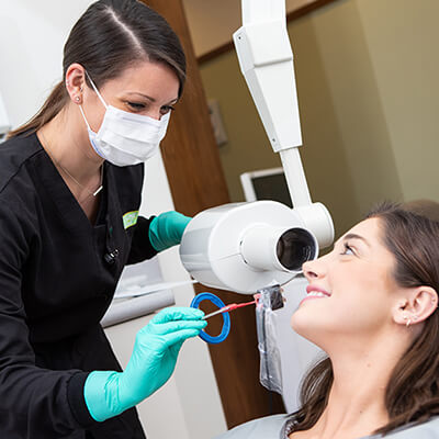 Female dental staff examining a female patient