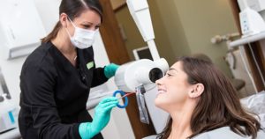 Dental assistant with CEREC patient taking an x-ray