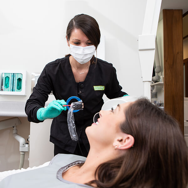 A female patient getting her teeth whitened